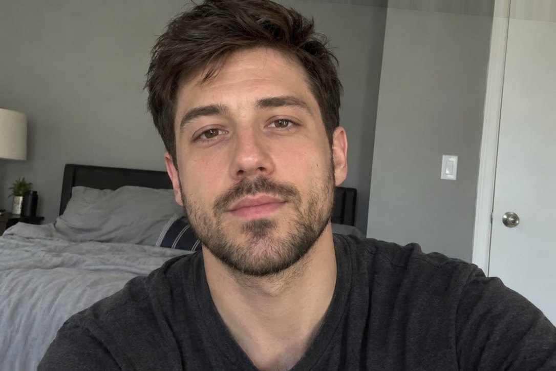 The identical AI-generated photo of a fictional young man in original daylight